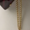 Kožená taška Prada Buckle s ozdobným páskem Kožená taška Prada Buckle s ozdobným páskem